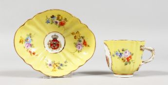 A 19TH CENTURY MEISSEN YELLOW GROUND CABARET CUP AND SAUCER crested and painted with flowers.