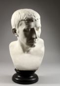 A CLASSICAL PLASTER BUST OF A ROMAN EMPEROR on a circular base. 19ins high.
