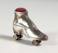 A SILVER SKATE PIN CUSHION.