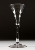 A GEORGIAN WINE GLASS with plain tapering bowl and stem. 6.75ins high.