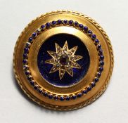 A VICTORIAN 15CT GOLD, ENAMEL, SAPPHIRE AND DIAMOND CIRCULAR BROOCH.