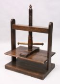 A GOOD 19TH CENTURY OAK TABLE TOP CLOTHES PRESS, with wood screw system. 2ft 2.5ins wide x 1ft