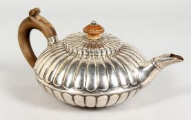 A GEORGE III SILVER CIRCULAR FLUTED TEAPOT AND COVER with wooden knop handle. London 1811. Makers: