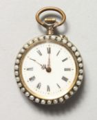 A LADIES' ENAMEL BACK FOB WATCH with seed pearl surround.