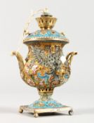 A MINIATURE RUSSIAN SILVER AND ENAMEL SAMOVA. Marks not clear. 3.5ins high.