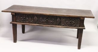 AN 18TH CENTURY SPANISH OAK SERVING TABLE with a single plank top, three carved frieze drawers on