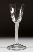 A LARGE GEORGIAN WINE GLASS with semi fluted bowl and air twist stem. 6.25ins high.