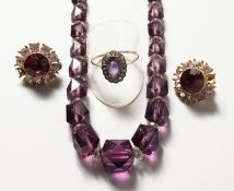 A BOXED SET of necklace, ring and earrings.