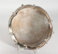 A SMALL ENGRAVED SILVER PLATED WAITER on claw and ball feet. 8ins diameter.