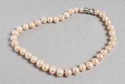 A PINK PEARL NECKLACE, with magnetic clasp. 17ins long.