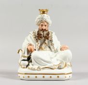 A FRENCH JACOB PETIT PORCELAIN FIGURE OF A SEATED TURK, white glaze decorated in gilt, his head as a