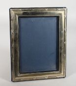 A SILVER PHOTOGRAPH FRAME with reeded edges. 10 high x 7.5ins wide. London 1973.