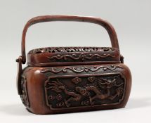 A CHINESE BRONZE CENSER / HAND WARMER, with pierced cover and carrying handle. 5.5ins wide.