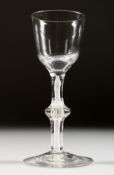 A GEORGIAN WINE GLASS with plain bowl, knop in the stem and white twist. 5.25ins high.