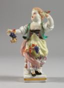 A SMALL MEISSEN PORCELAIN FIGURE OF A YOUNG GIRL carrying grapes. Cross swords mark in blue. 4ins