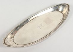 A GEORGE III OVAL SILVER SNUFFER TRAY with bead edge, bird crest. 9ins long. London 1782. Maker
