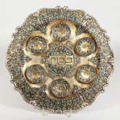 A RUSSIAN SILVER AND ENAMEL CIRCULAR SEDER PLATE with scrolled border, six applied dishes with