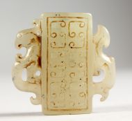 A SMALL CARVED JADE ARCHAIC STYLE PENDANT. 2ins high.