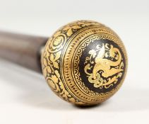 A 19TH CENTURY ROSEWOOD CANE with gold inlaid handle. 34ins long.