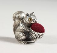 A SILVER SQUIRREL PIN CUSHION.