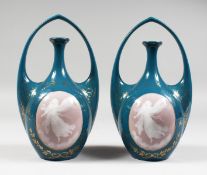 A RARE PAIR OF GERMAN ART DECO TWO HANDLED VASES with pate-sur-pate oval of winged angels. Printed