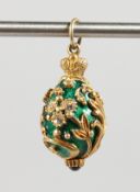 A RUSSIAN GREEN ENAMEL AND SILVER EGG SHAPED PENDANT.