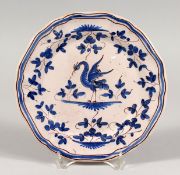 A FAIENCE BLUE AND WHITE PLATE with a crest. 8.5ins diameter.