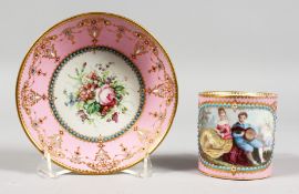 A GOOD 18TH CENTURY SEVRES PINK GROUND CUP AND SAUCER, the cup painted with a boy with guitar, a