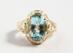 A SUPERB 18CT YELLOW GOLD AND AQUAMARINE 5.30cts RING, surrounded by small diamonds.