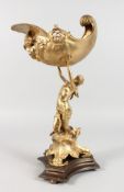 A GILT BRONZE CENTREPIECE, modelled as a lady holding aloft a conch shell. 15.5ins high.