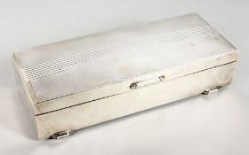A LARGE ENGINE TURNED SILVER TWO DIVISION CIGARETTE BOX. 9ins long. Birmingham 1964.