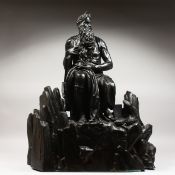AFTER MICHELANGELO - AN IMPRESSIVE LARGE BRONZE OF MOSES seated on rocks, a tablet under his arm.