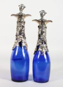 A SMALL PAIR OF BRISTOL BLUE GLASS BOTTLES with plated fruiting vines, mounts and corks.