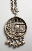 A CHINESE SILVER CIRCULAR PENDANT AND CHAIN. 1.5ins diameter.