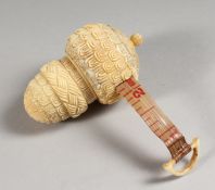 A CARVED BONE ACORN TAPE MEASURE.