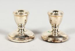 A SMALL PAIR OF SILVER CANDLESTICKS in a blue box. Birmingham 1963.