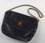 A BLACK CHANEL FOLDING BAG.