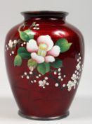 A JAPANESE CLOISONNE VASE, red ground decorated with flowers. 6ins high.