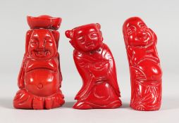THREE CHINESE CARVED CORAL FIGURES. 2.25ins x 2.5ins high.