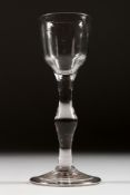 A GEORGIAN WINE GLASS with plain bowl and stem, with a knop. 6ins high.