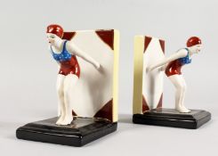A PAIR OF ART DECO STYLE PORCELAIN BOOK ENDS of female swimmers. 6ins high.
