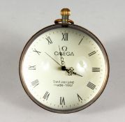 A NOVELTY DESK CLOCK, modelled as a glass orb style pocket watch. 3ins diameter.