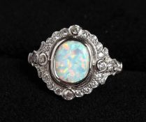 A SILVER AND GILSON OPAL RING.