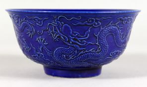 A DARK BLUE GROUND CHINESE BOWL with moulded decoration. 6ins diameter.