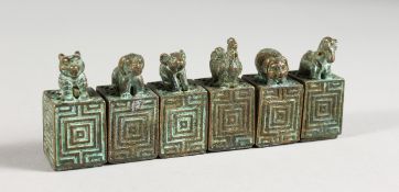 SIX MINIATURE CHINESE BRONZE SEALS / SCROLL WEIGHTS.
