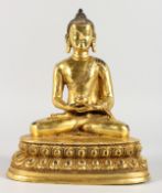 A THAI GILT BRONZE BUDDHA, seated in the lotus position. 9ins high.