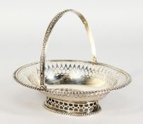 A GARRARD'S PIERCED OVAL SILVER BASKET with swing handle. London 1900.
