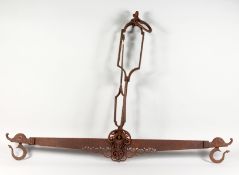 AN EARLY SPANISH WROUGHT IRON SET OF HANGING SCALES. 46ins wide x 36ins high.