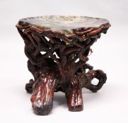 AN UNUSUAL FLUORITE AND ROOTWOOD LOW TABLE. 23ins wide x 20ins high.