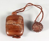 A JAPANESE WOOD INRO, carved with a dragonfly. 2ins wide.